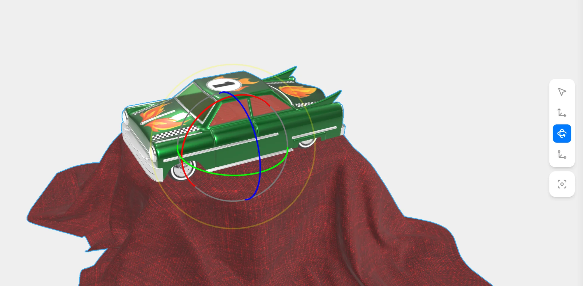 Toy Car with the Rotation tool active in the transform toolbar and the red, green and blue rotation rings on the model